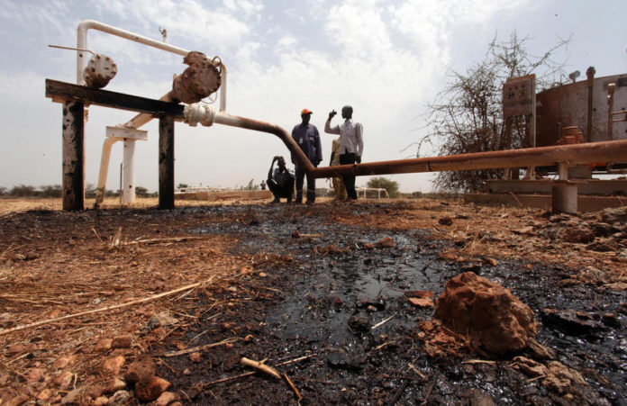 An oil well oozes crude oil after it was hit by a shrapnel from a bomb dropped by fighter jets at the El Nar oil field in South Sudan's Unity State